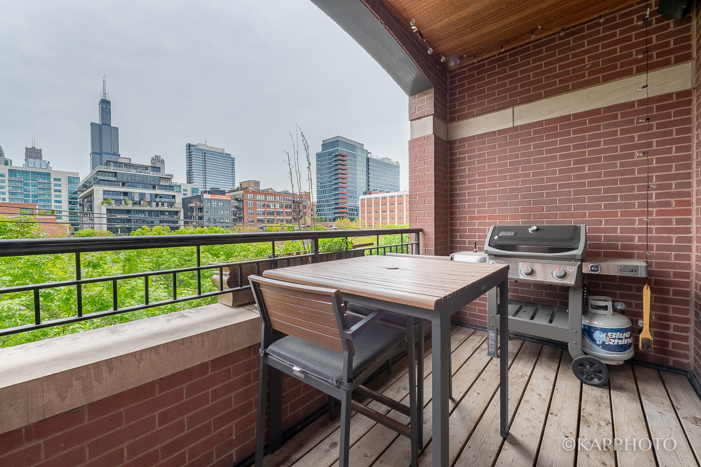 106 South Sangamon Street, Unit 3N Chicago, IL 60607 - Photo 7 of 27 a balcony with a table and chairs
