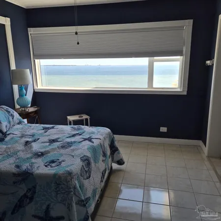 a bedroom with a bed and a couch