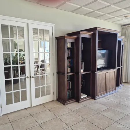 a room with furniture mirror and window