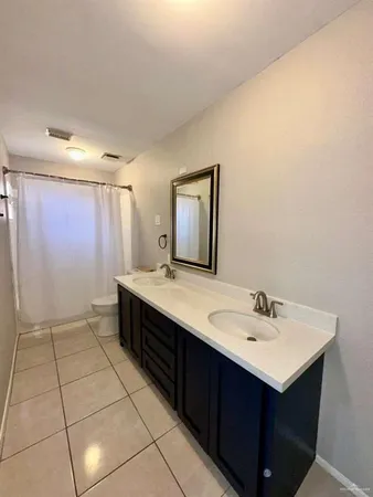 a bathroom with a sink vanity and mirror