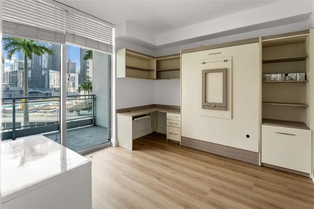 a view of a livingroom with wooden floor and a ceiling fan