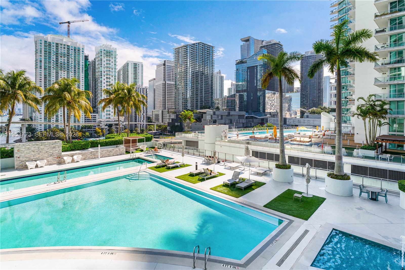 90 Southwest 3rd Street, Unit 1115 Miami, FL 33130 - Photo 14 of 17 a view of swimming pool with outdoor seating and a garden