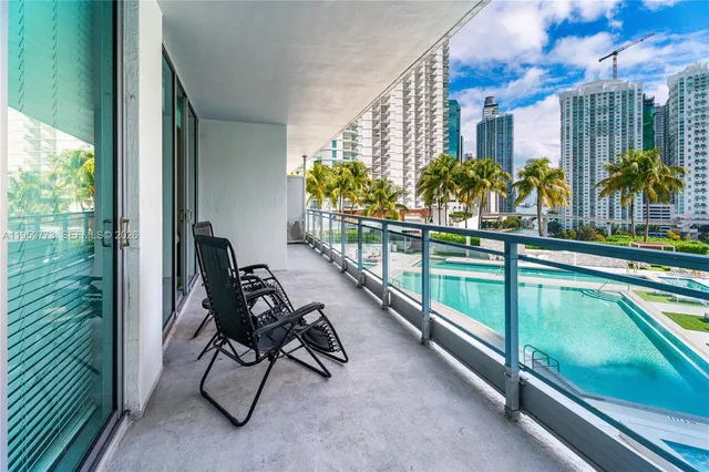 a view of a chairs and table in patio with wooden fence