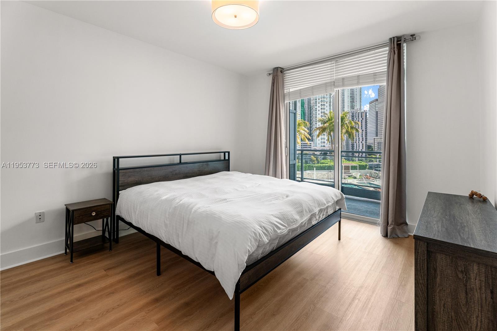 90 Southwest 3rd Street, Unit 1115 Miami, FL 33130 - Photo 4 of 17 a bedroom with a bed and a window