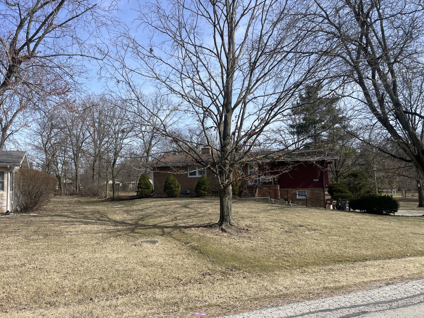 a view of a house with a yard covered in snow