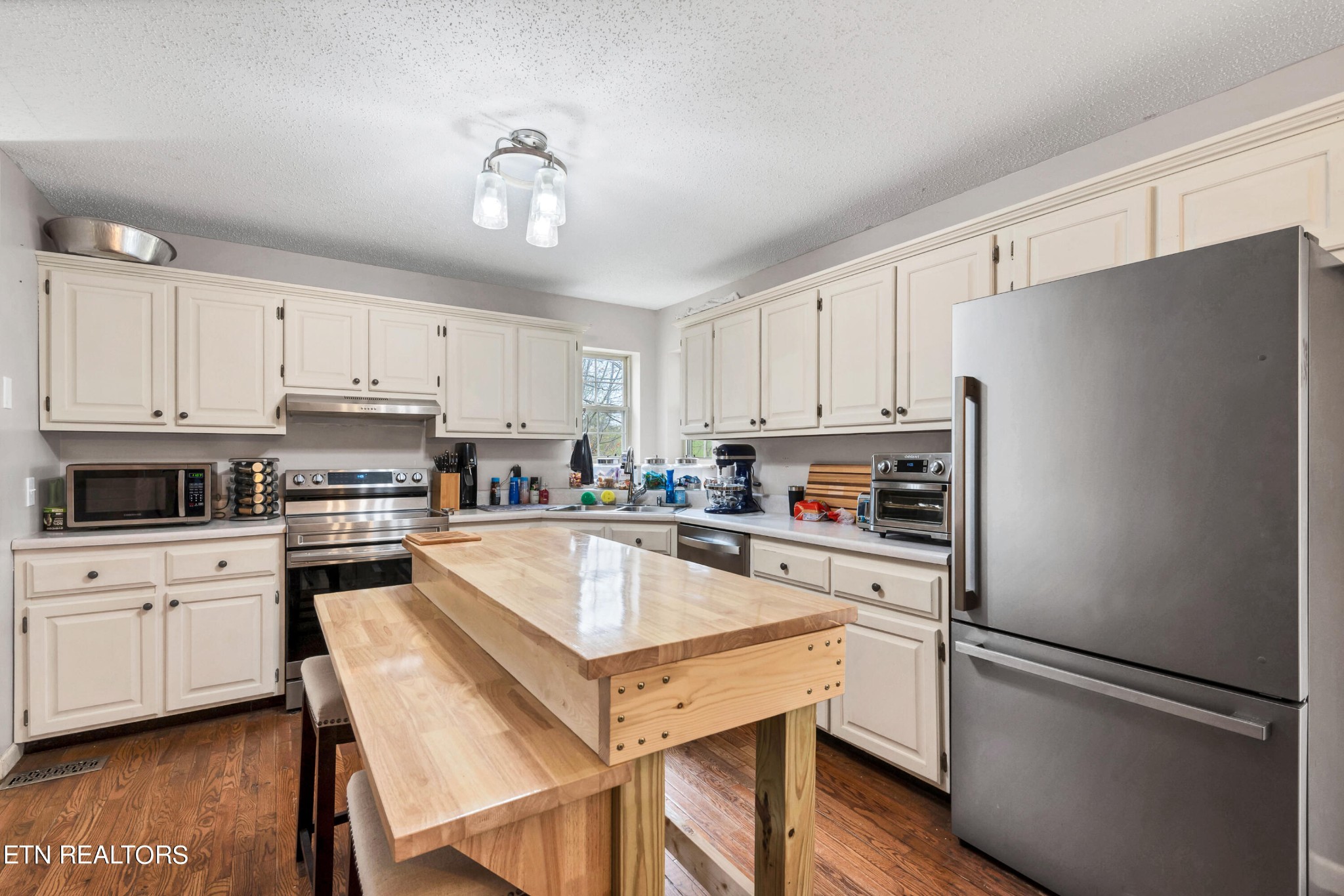 165 Colditz Oneida, TN 37841 - Photo 16 of 57 a kitchen with cabinets stainless steel appliances and wooden floor