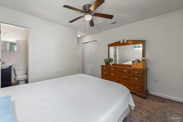 a bedroom with a bed and a dresser