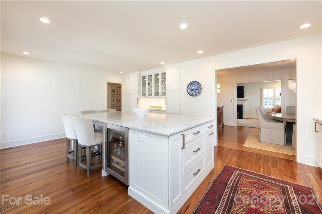2901 Idlewood Circle Charlotte, NC 28209 - Photo 20 of 48 a hallway with white cabinets and wooden floor