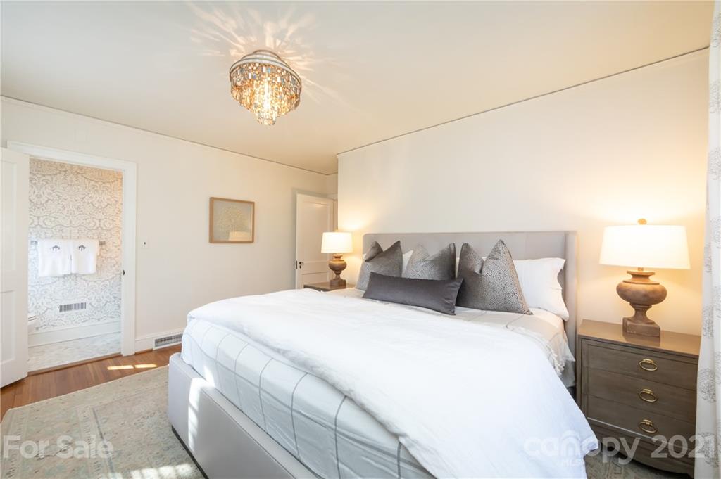 2901 Idlewood Circle Charlotte, NC 28209 - Photo 24 of 48 a bedroom with a bed and a chandelier
