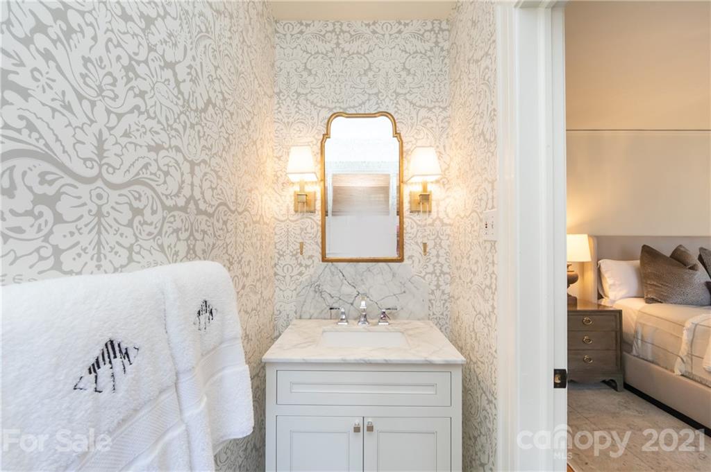2901 Idlewood Circle Charlotte, NC 28209 - Photo 26 of 48 a en suite bathroom with a granite countertop sink and a mirror