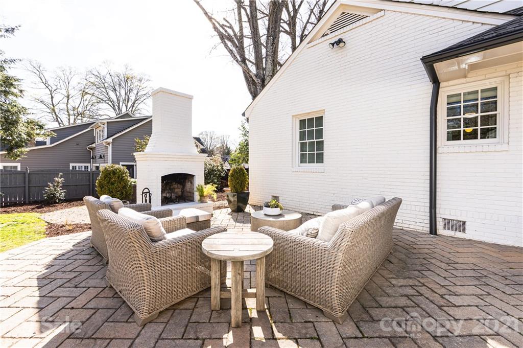 2901 Idlewood Circle Charlotte, NC 28209 - Photo 46 of 48 a view of a patio with couches table and chairs under an umbrella