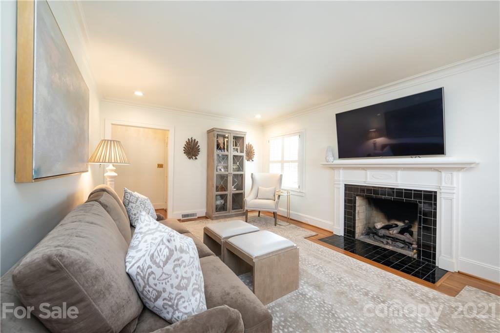 2901 Idlewood Circle Charlotte, NC 28209 - Photo 9 of 48 a living room with furniture a flat screen tv and a fireplace