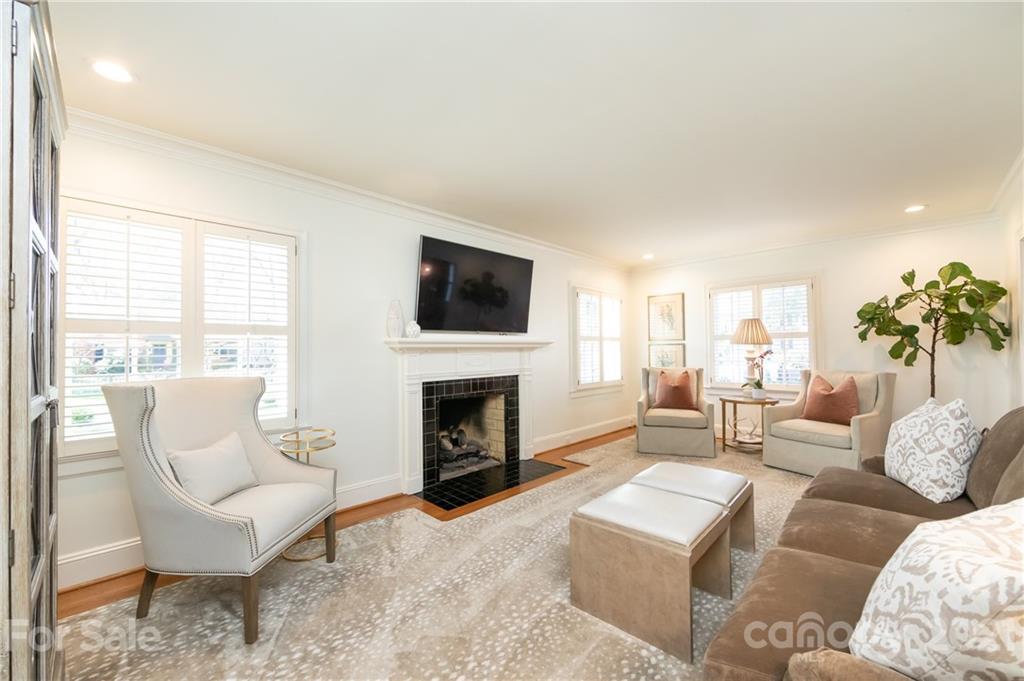 2901 Idlewood Circle Charlotte, NC 28209 - Photo 10 of 48 a living room with furniture a fireplace and a flat screen tv