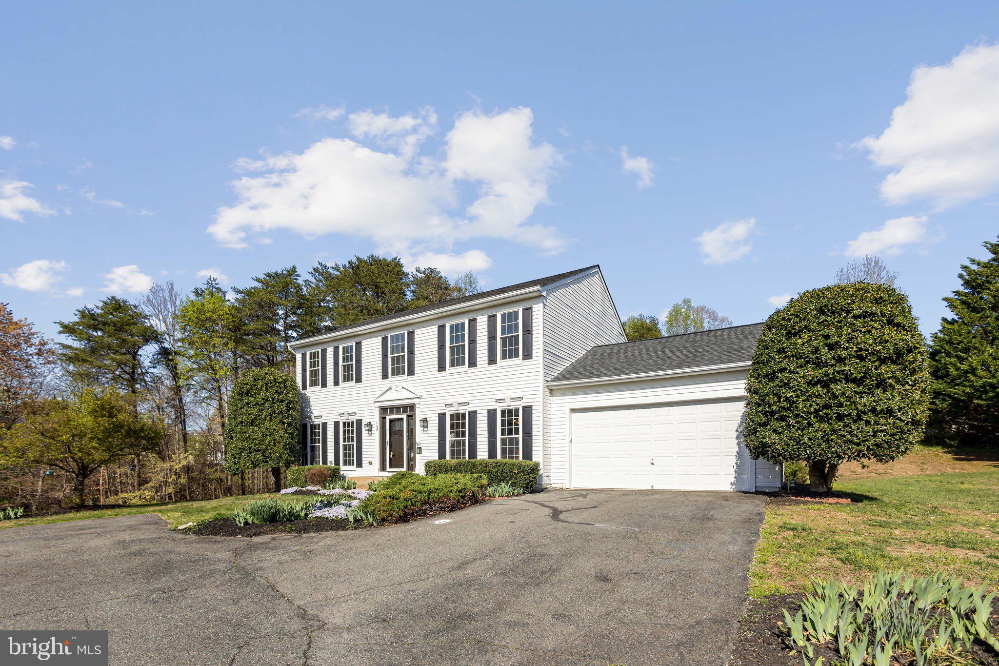 169 Basalt Drive Fredericksburg, VA 22406 - Photo 1 of 56 a front view of a house with a garden and trees