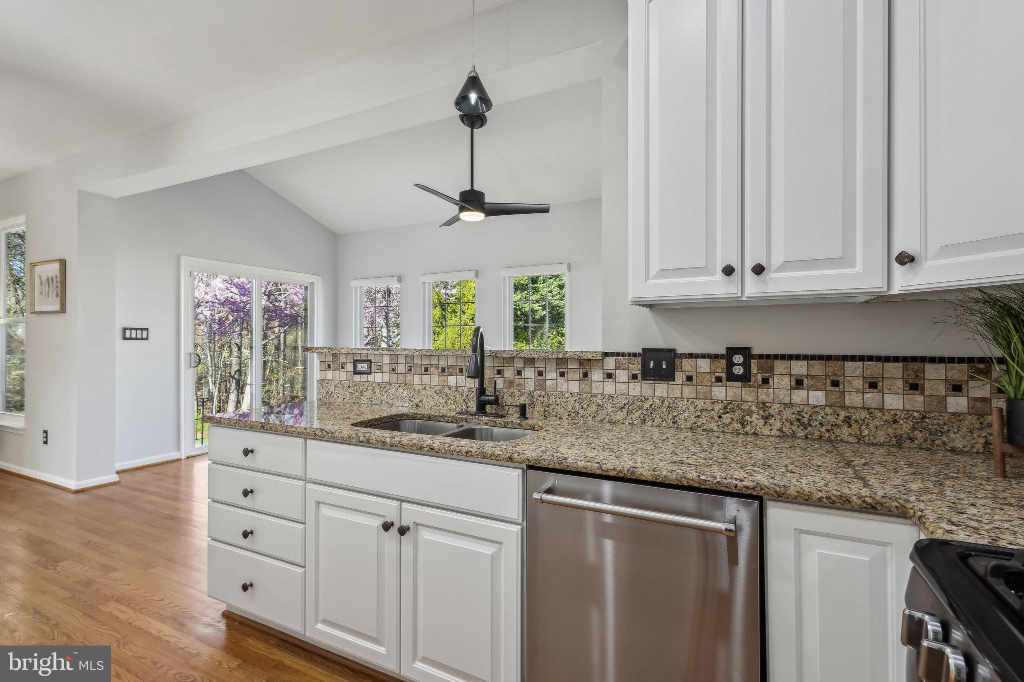 169 Basalt Drive Fredericksburg, VA 22406 - Photo 18 of 56 a kitchen with stainless steel appliances granite countertop a sink a stove and white cabinets