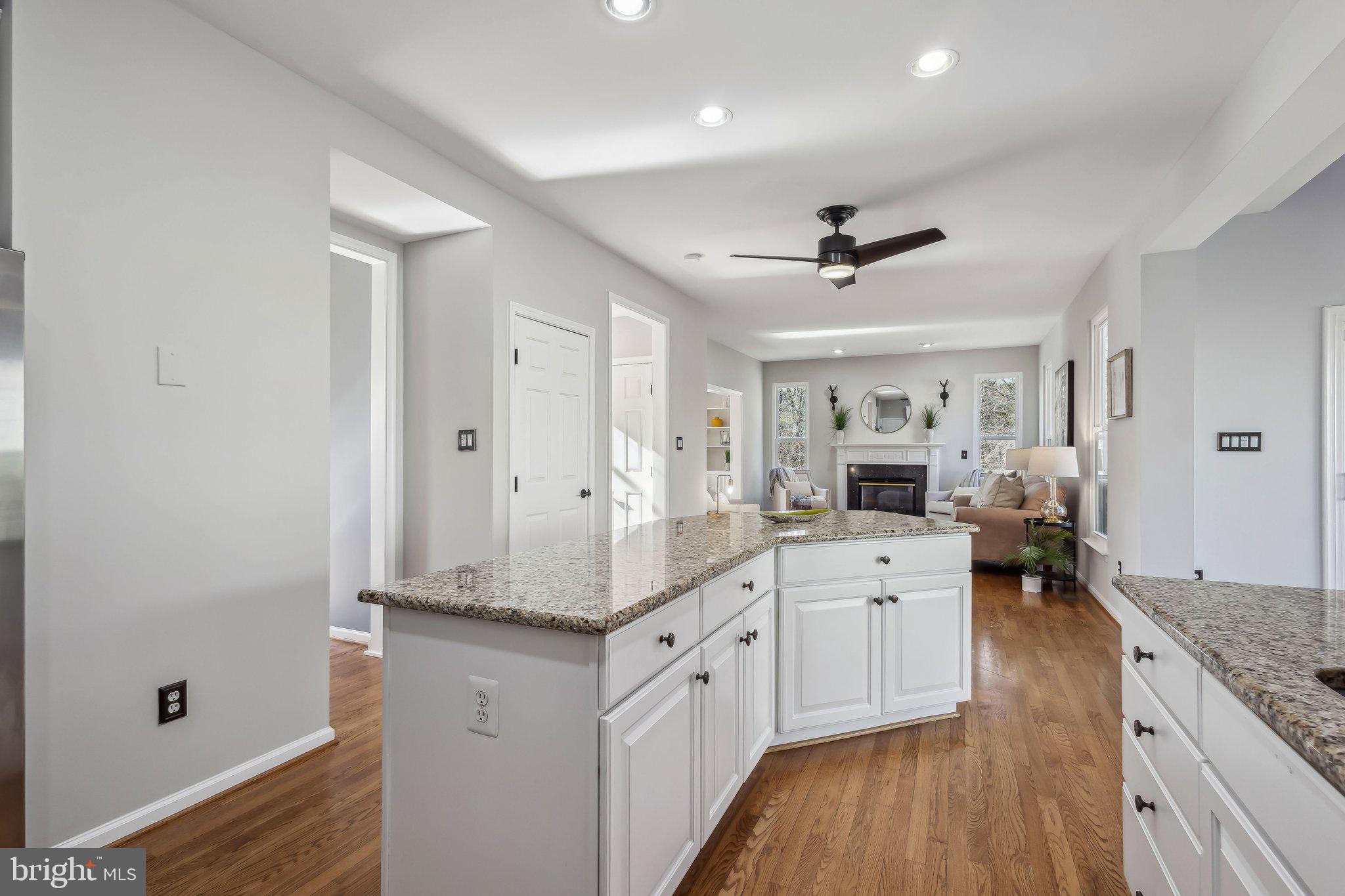 169 Basalt Drive Fredericksburg, VA 22406 - Photo 19 of 56 a large white kitchen with a lot of counter space wooden floor and a ceiling fan