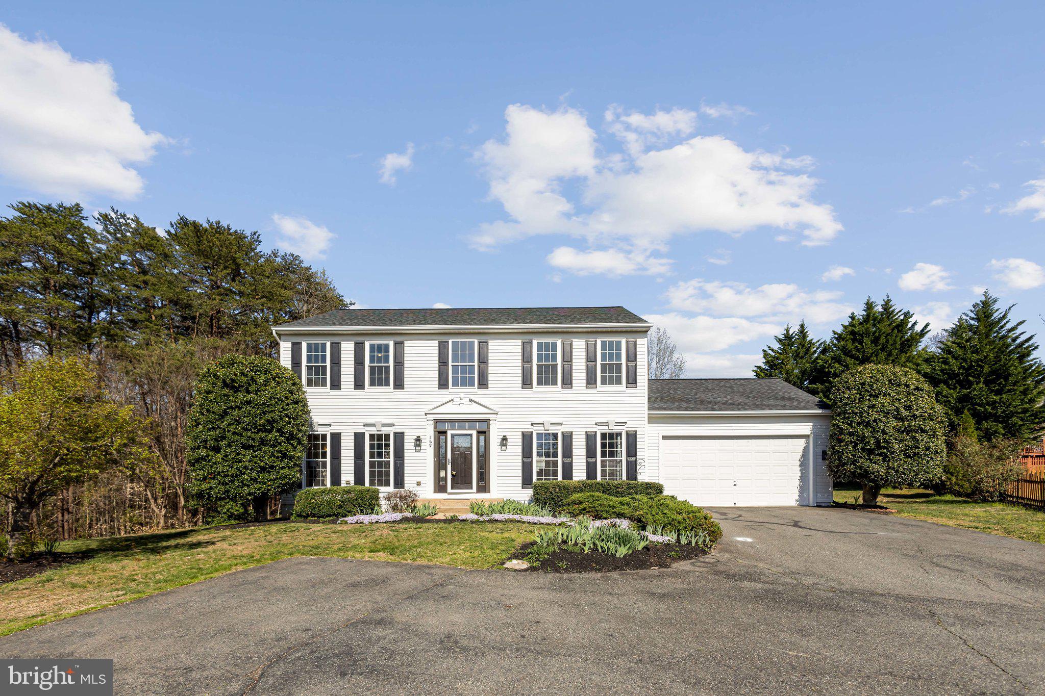169 Basalt Drive Fredericksburg, VA 22406 - Photo 2 of 56 a front view of a house with a garden and trees