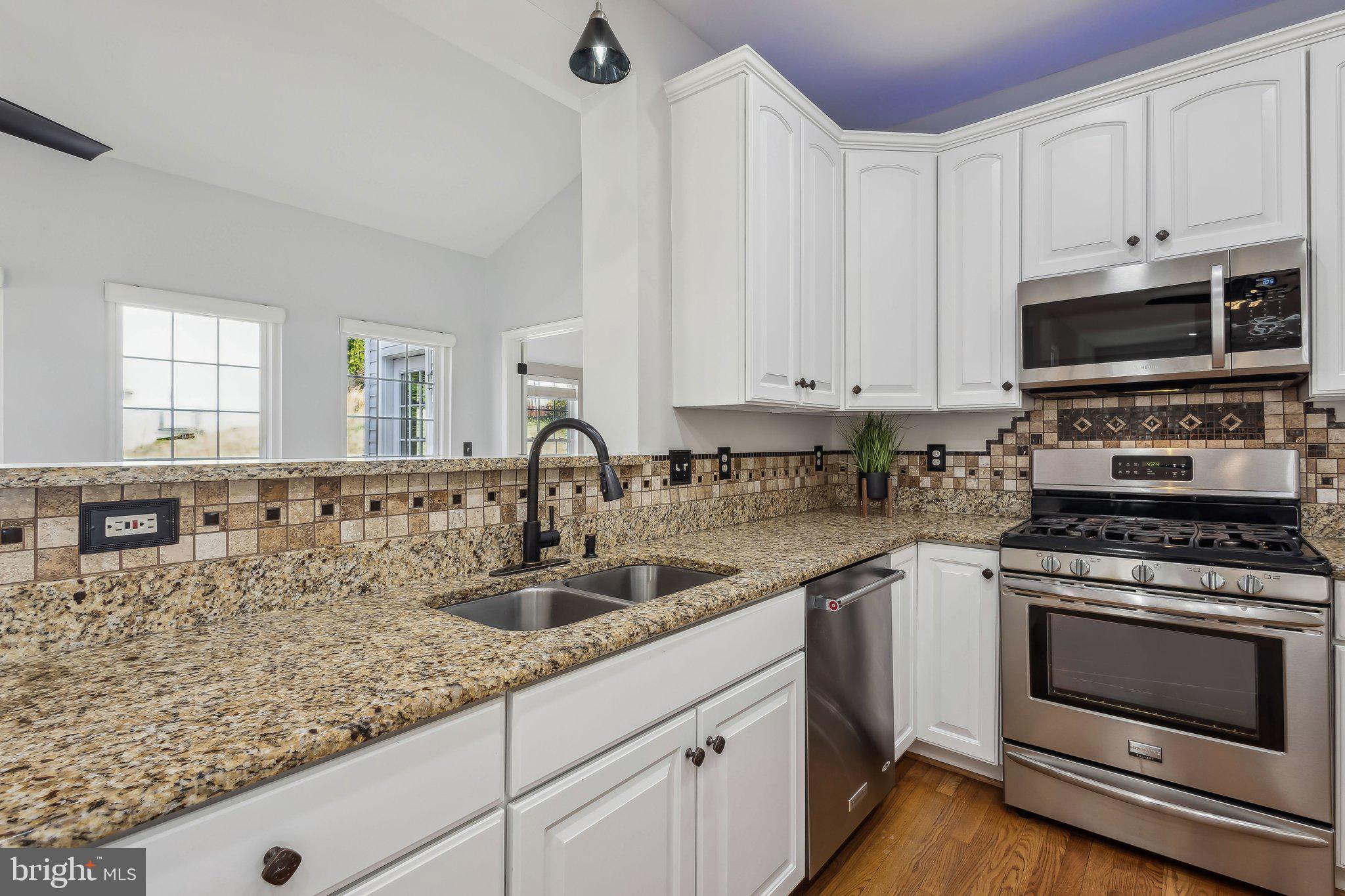169 Basalt Drive Fredericksburg, VA 22406 - Photo 21 of 56 a kitchen with granite countertop a sink a stove and cabinets