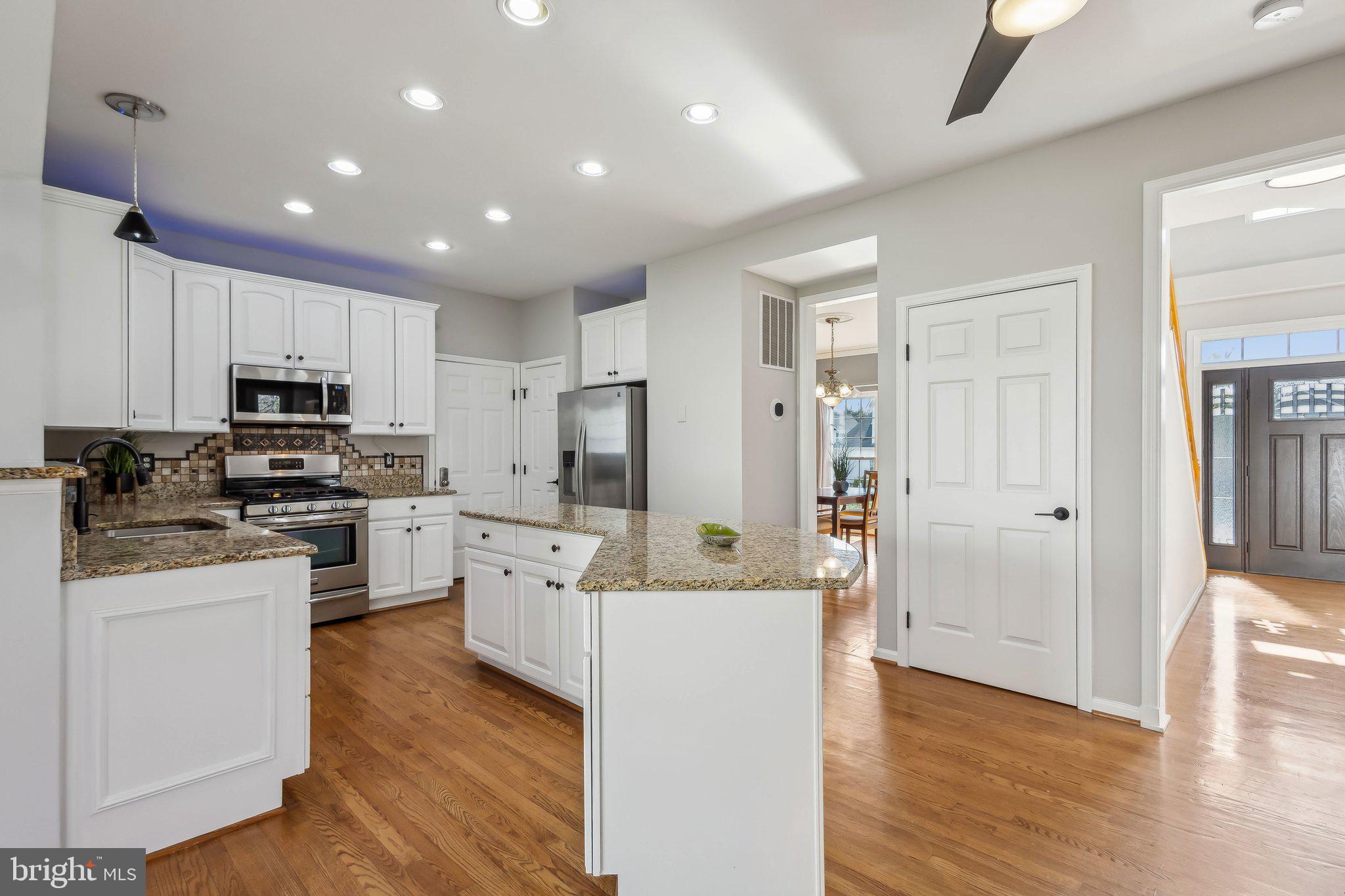 169 Basalt Drive Fredericksburg, VA 22406 - Photo 22 of 56 a kitchen with white cabinets and stainless steel appliances