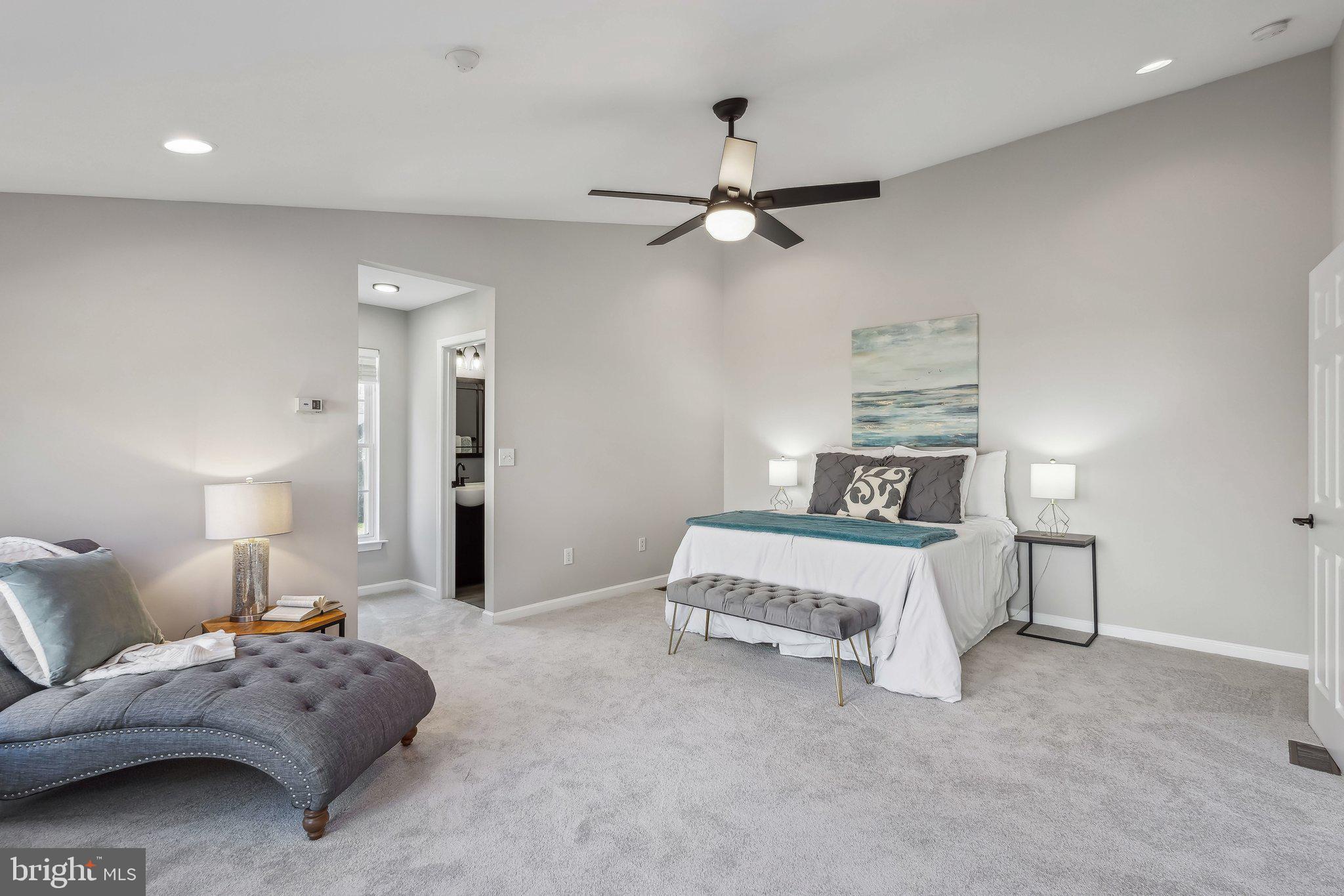 169 Basalt Drive Fredericksburg, VA 22406 - Photo 28 of 56 a bedroom with a bed and a chandelier