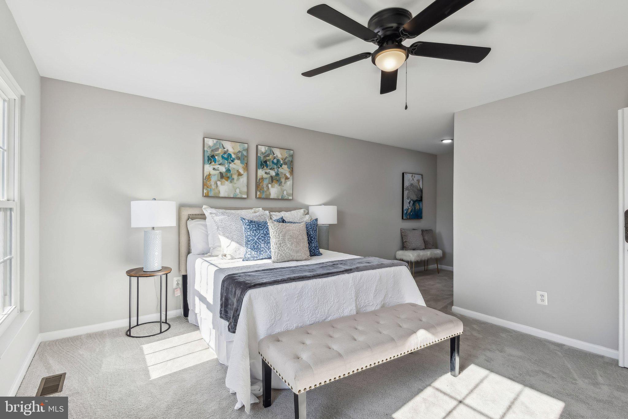 169 Basalt Drive Fredericksburg, VA 22406 - Photo 37 of 56 a bedroom with a bed and a chandelier