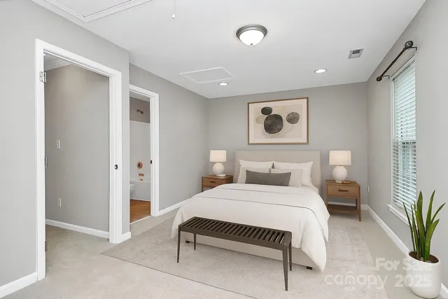 a bedroom with a large bed and a potted plant