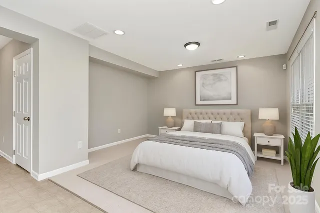 a bedroom with a large bed and potted plant