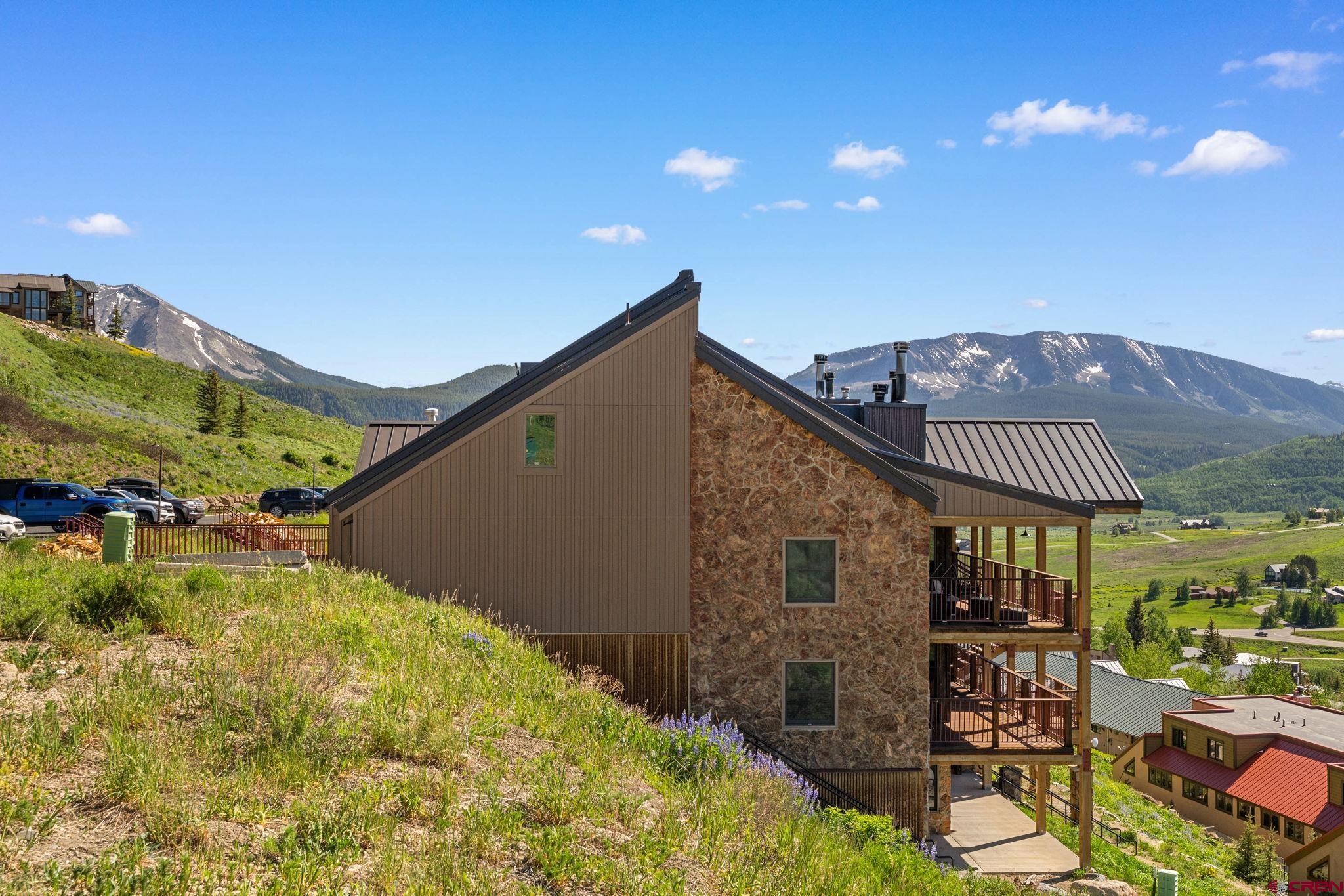 72 Hunter Hill Road, Unit I204 Crested Butte, CO 81225 - Photo 41 of 44 a front view of a house with a yard