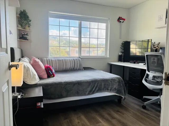 a bedroom with a bed and a window