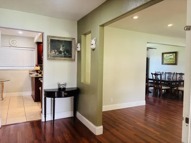 a living room with wooden floor and furniture