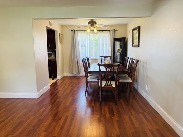 a view of a dining room with furniture and wooden floor