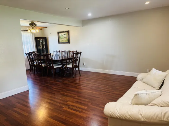 a view of a dining room with furniture and wooden floor