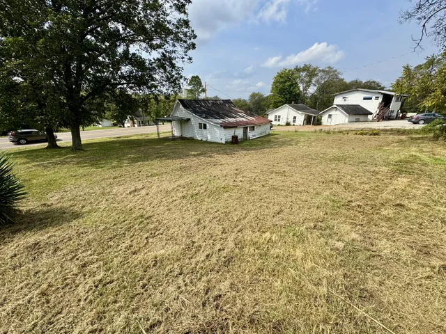 a view of swimming pool with outdoor seating and covered with trees
