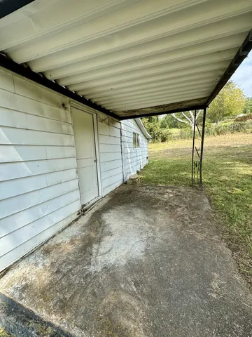 a view of a big room with wooden floor and windows