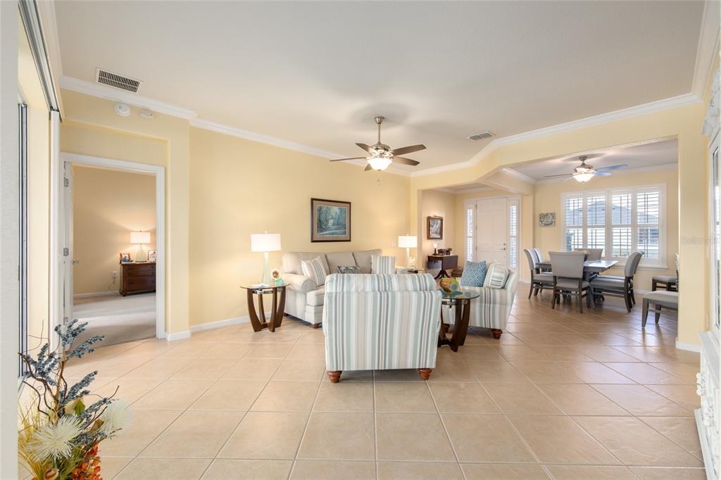 9479 Southwest 71st Loop Ocala, FL 34481 - Photo 31 of 84 a living room with furniture and a dining table with kitchen view