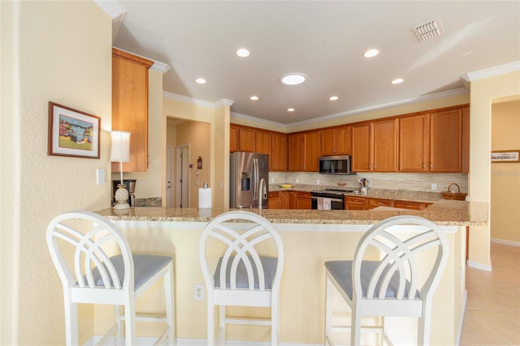9479 Southwest 71st Loop Ocala, FL 34481 - Photo 36 of 84 a kitchen with stainless steel appliances granite countertop furniture a refrigerator a sink and a stove