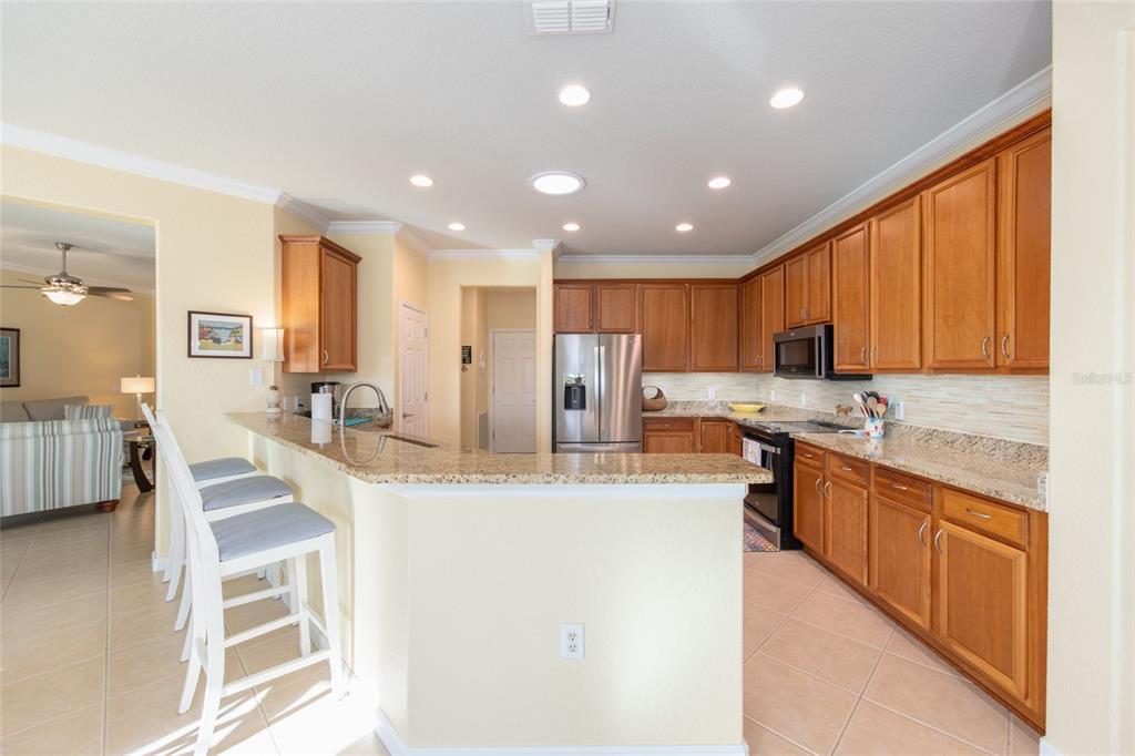9479 Southwest 71st Loop Ocala, FL 34481 - Photo 38 of 84 a large kitchen with granite countertop lots of counter space and stainless steel appliances