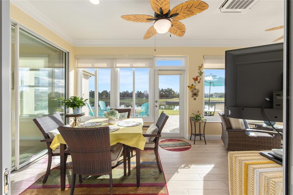 9479 Southwest 71st Loop Ocala, FL 34481 - Photo 47 of 84 a dining room with furniture a flat screen tv and a large window
