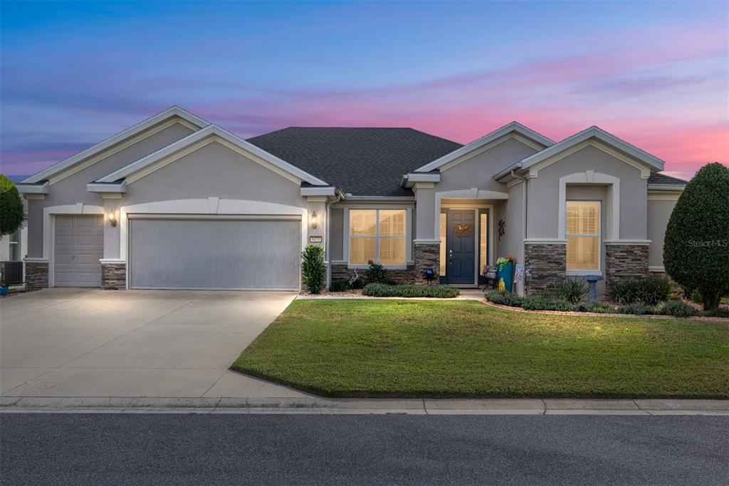 9479 Southwest 71st Loop Ocala, FL 34481 - Photo 7 of 84 a front view of a house with a yard and garage