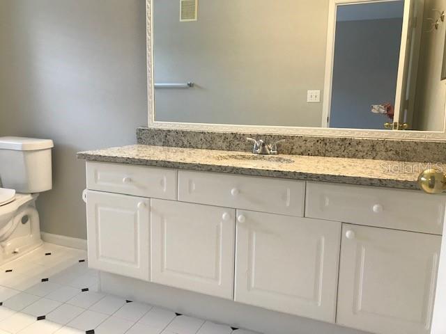 599 Campus Street, Unit 599 Celebration, FL 34747 - Photo 13 of 24 a bathroom with a sink and a toilet