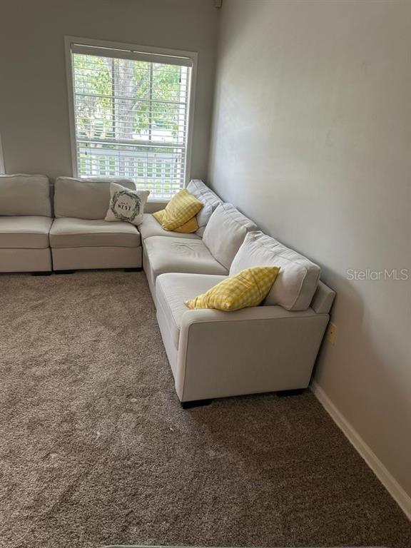 599 Campus Street, Unit 599 Celebration, FL 34747 - Photo 18 of 24 a living room with furniture and a window