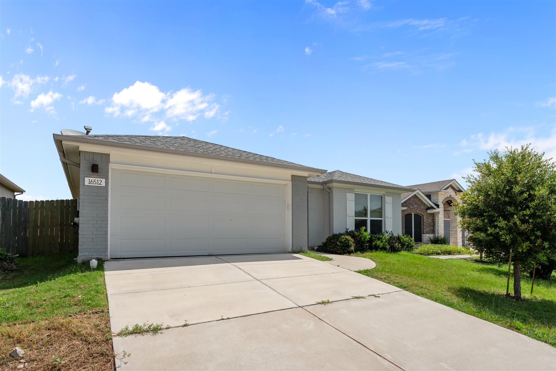 16512 Enamorado Road Manor, TX 78653 - Photo 13 of 31 A welcoming facade presents a two-car garage and neatly maintained landscaping.