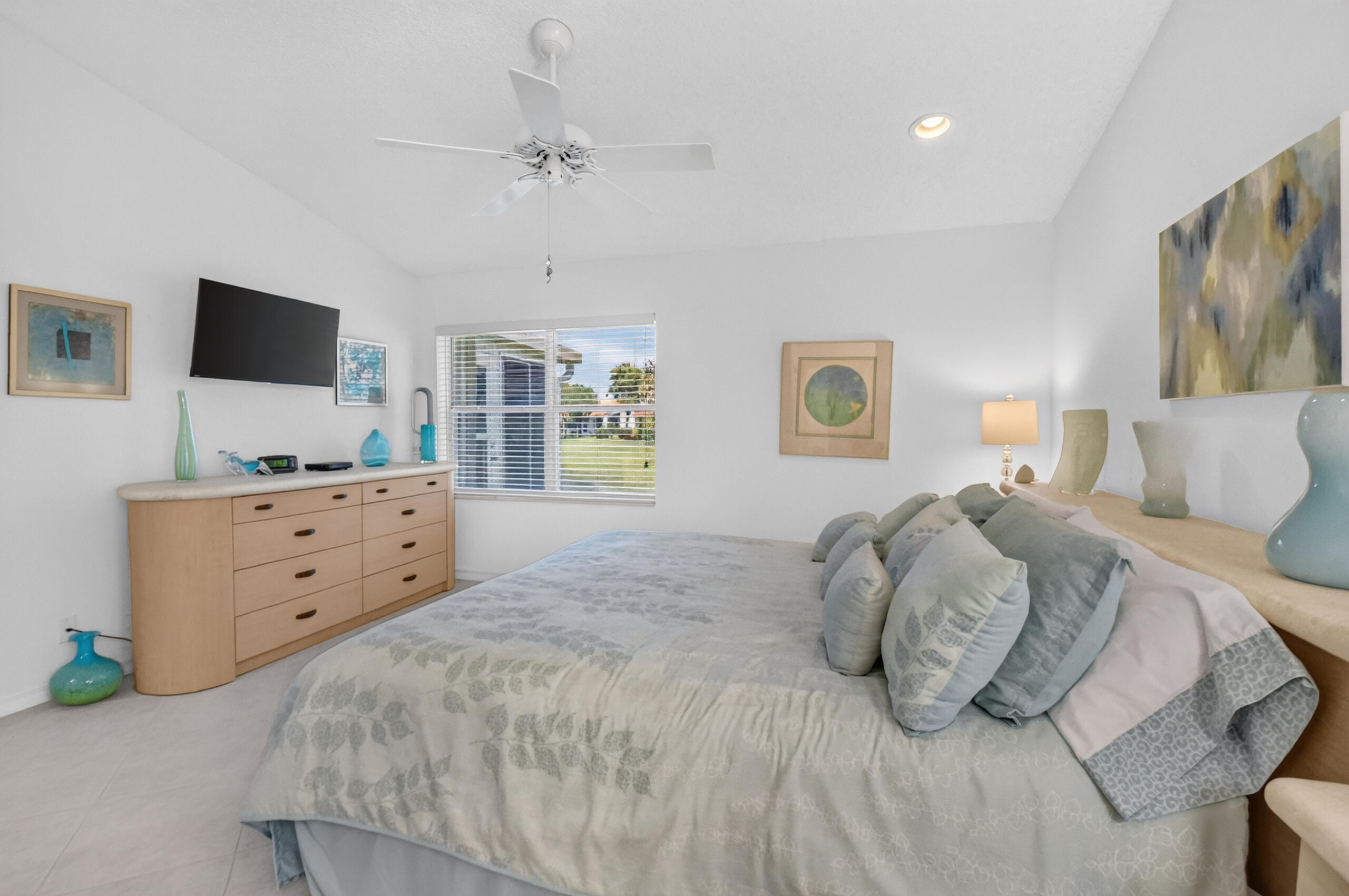 15340 Floral Club Road Delray Beach, FL 33484 - Photo 22 of 42 a bedroom with a large bed and a flat tv screen on dresser
