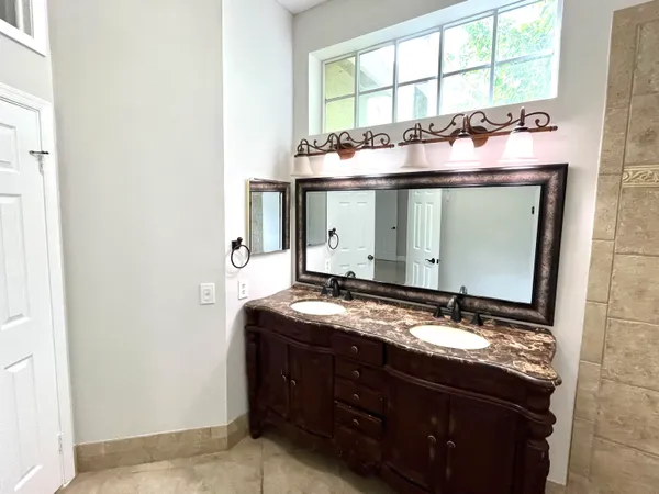 a bathroom with a sink vanity mirror and toilet