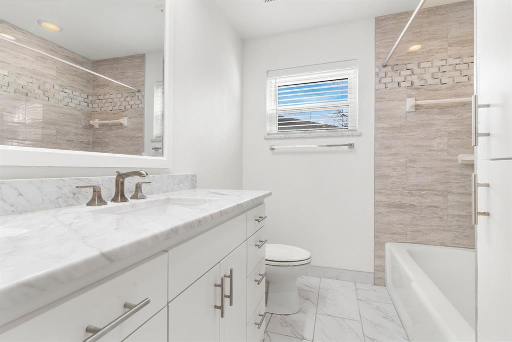 831 Warren Way Richardson, TX 75080 - Photo 11 of 18 a bathroom with a granite countertop sink toilet and shower