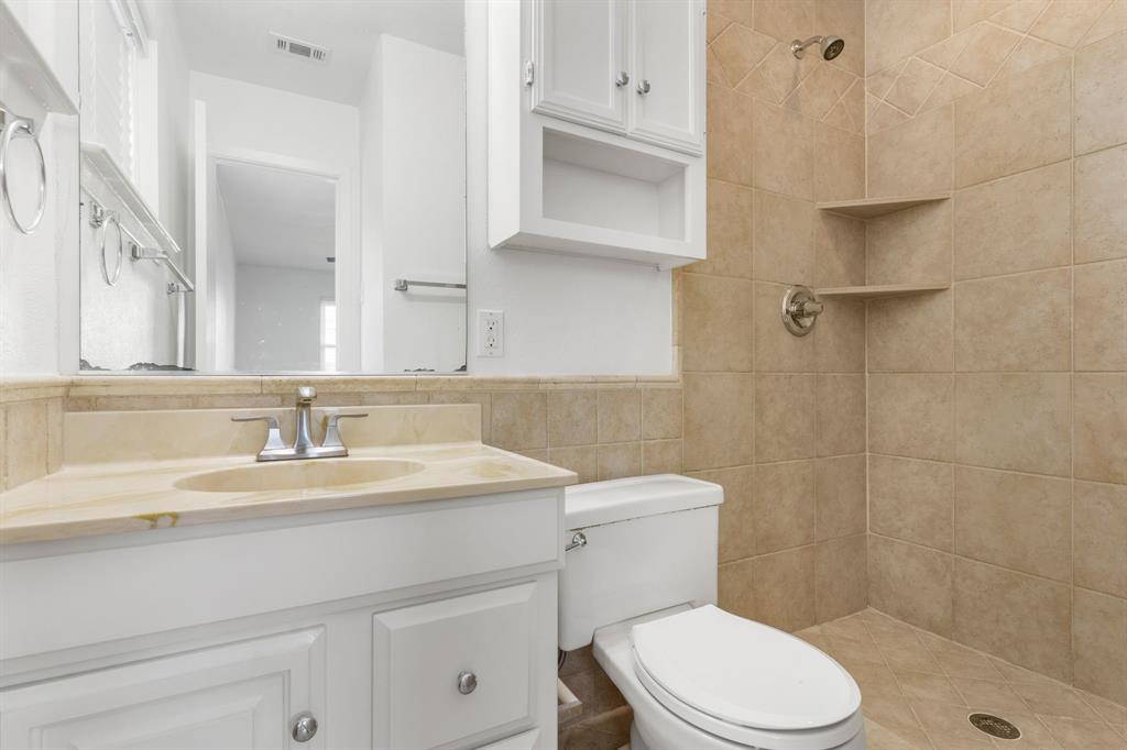 831 Warren Way Richardson, TX 75080 - Photo 13 of 18 a bathroom with a sink a toilet and shower