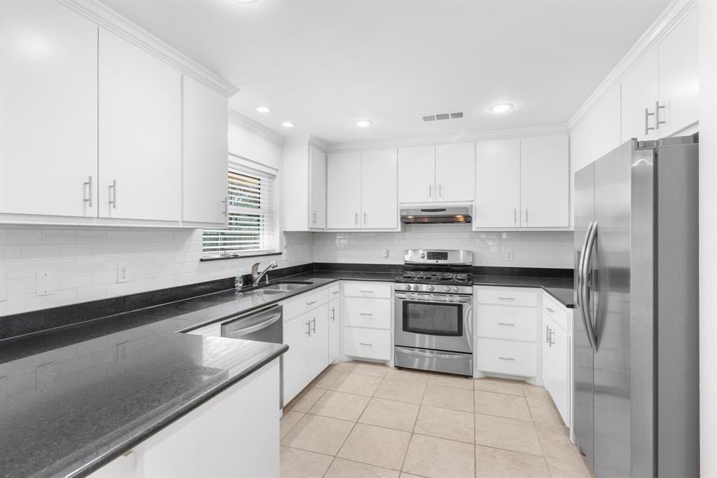 831 Warren Way Richardson, TX 75080 - Photo 4 of 18 a kitchen with stainless steel appliances granite countertop a sink and a stove