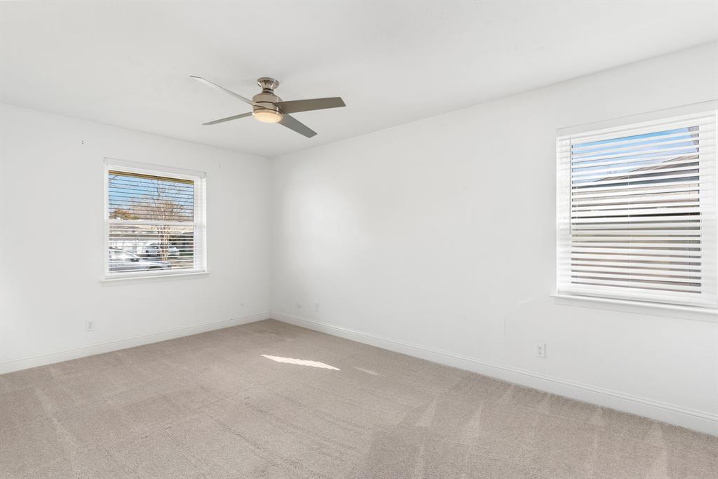 831 Warren Way Richardson, TX 75080 - Photo 10 of 18 an empty room with a window and a ceiling fan