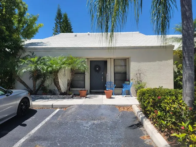 a view of a patio with table and chairs potted plants