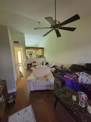 a view of a hallway to a house with stairs